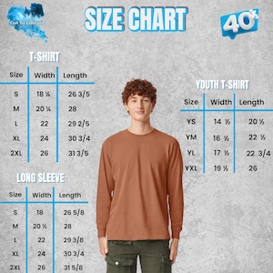 May include: A size chart for t-shirts and long sleeve shirts, with measurements in inches. The chart includes sizes for adults and youth, with width and length dimensions. A man wearing a brown long-sleeve shirt is in the center of the image.