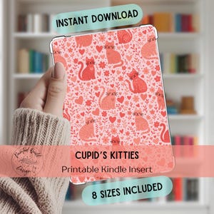 May include: A Kindle insert with a pink background featuring a pattern of red and coral cats, hearts, and floral elements. The text "Cupid's Kitties" and "Printable Kindle Insert" are displayed. The words "Instant Download" and "8 Sizes Included" are also visible.