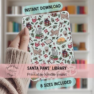 May include: A light blue Kindle insert with a festive cat-themed design. The insert features illustrations of cats wearing Santa hats, books, gifts, and candy canes. Text on the insert reads "SANTA PAWS' LIBRARY" and "8 SIZES INCLUDED".