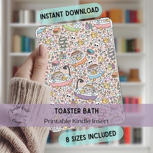 May include: A Kindle insert with a whimsical "Toaster Bath" design. The insert features a repeating pattern of cartoon toasters in bathtubs, rubber ducks, and skulls, with the text "Instant Download" and "8 Sizes Included".