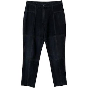 May include: High-waisted black pants featuring a paneled construction with visible vertical and horizontal topstitched seams. The garment includes a central zipper fly, a button closure at the waistband, and a straight-leg cut with a matte finish.