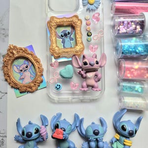 May include: A clear phone case decorated with a blue flower, a gold frame with a Stitch image, and various charms. Several Stitch figurines in different poses are also present. Glitter tubes in pink, blue, and purple are visible.