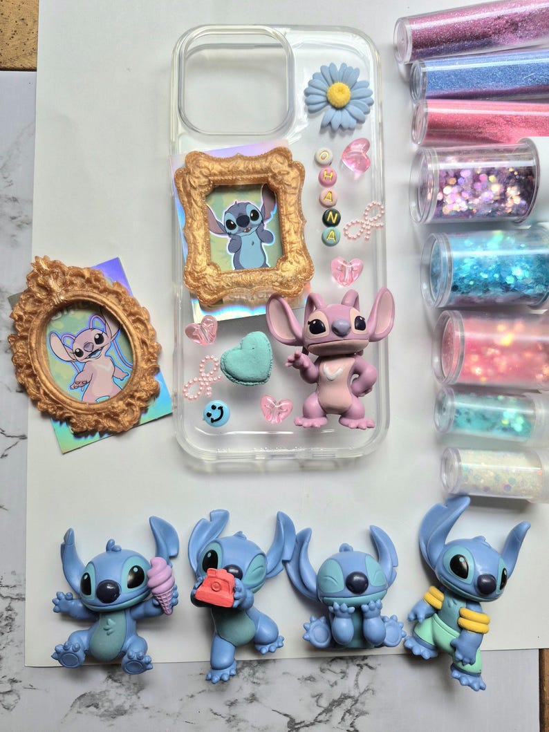 May include: A clear phone case decorated with a blue flower, a gold frame with a Stitch image, and various charms. Several Stitch figurines in different poses are also present. Glitter tubes in pink, blue, and purple are visible.