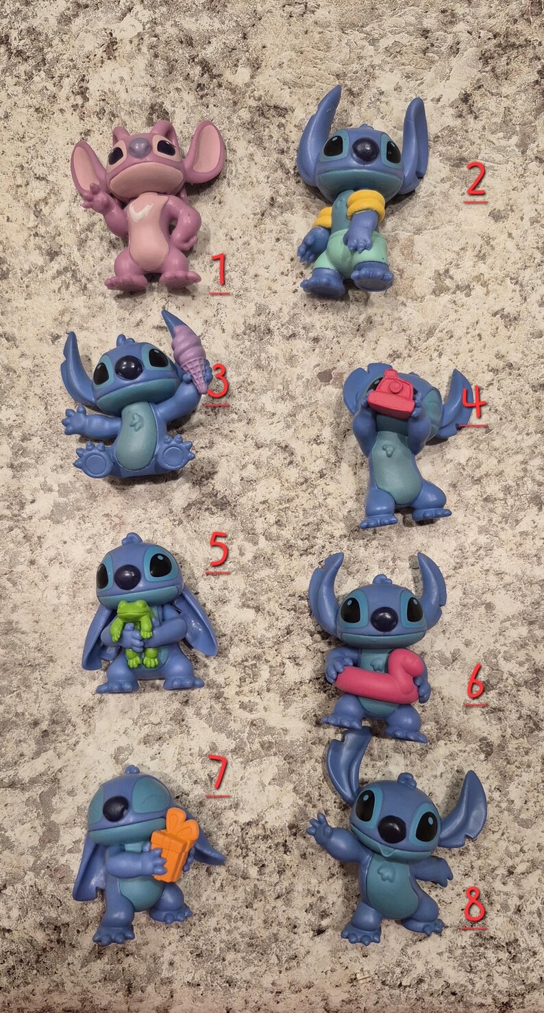 May include: A collection of eight small, colorful Stitch figurines. The figurines are in various poses, some holding accessories like ice cream cones and cameras. The color palette includes shades of blue, pink, and green.