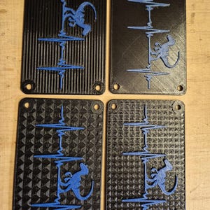 May include: Four black rectangular panels with a blue design. Each panel features a blue illustration of a monkey climbing a line, with a heartbeat-like pattern. The panels have rounded corners and holes for mounting.