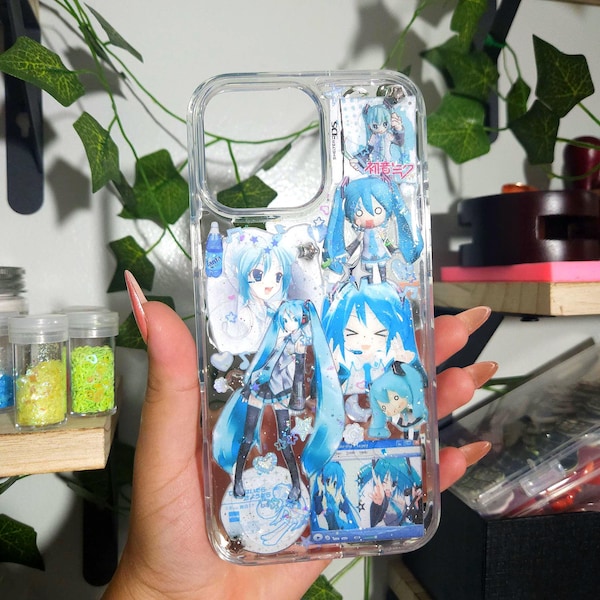 May include: A clear phone case decorated with multiple stickers of the character Hatsune Miku in various poses and outfits, featuring blue and white color schemes, star accents, and Japanese text integrated into the collage design.