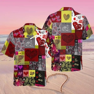 May include: Two short-sleeved shirts with a patchwork design featuring hearts, paisley, and the phrases "It's Love Baby" and "Be Mine." The shirts have a variety of colours including red, yellow, grey, and black.