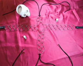 A thigh hair shirt in the shape of a cross, a symbol of strength and sensuality.