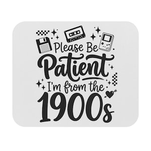 May include: White square coaster with black graphics and text. The design includes a floppy disk, cassette tape, and a handheld game console. The text reads "Please Be Patient I'm from the 1900s."