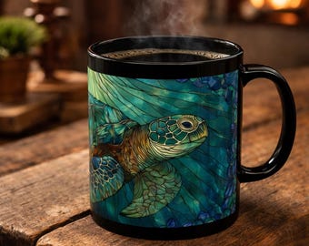 May include: A black ceramic mug with a detailed illustration of a sea turtle in shades of green, blue, and brown. The mug is filled with hot coffee, and steam rises from the top. The mug sits on a wooden surface.