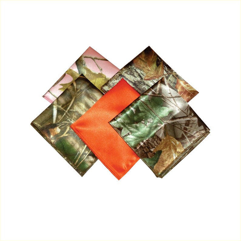 May include: Four fabric squares in different camouflage patterns. One square is pink, one is orange, and two are green and brown.