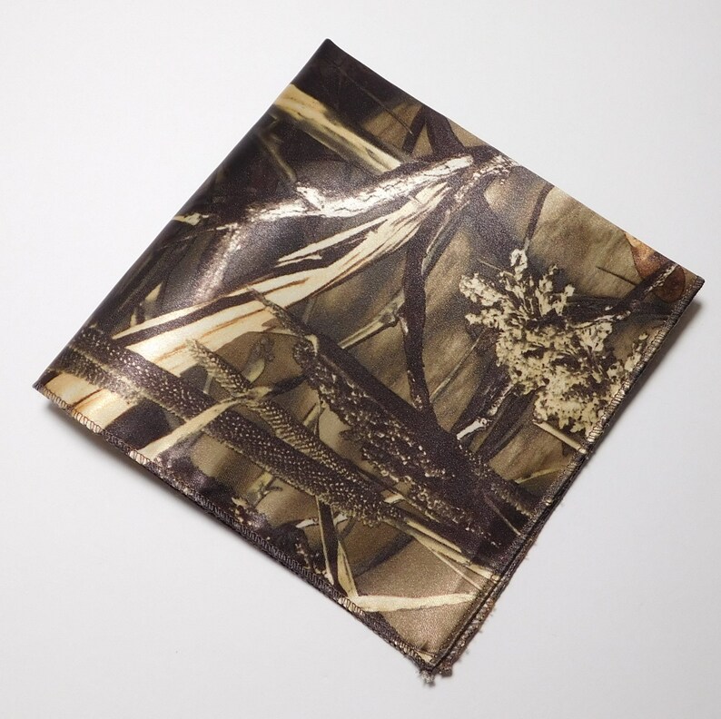 May include: A brown and tan camouflage patterned fabric pocket square.