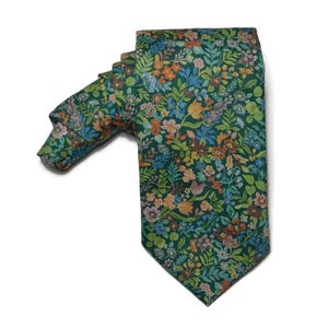 May include: A green silk tie with a floral pattern. The pattern features a variety of colorful flowers and leaves.