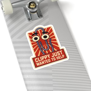 May include: A sticker featuring a cartoon paperclip character with large eyes and a friendly expression. The paperclip is set against a red and cream burst background, with the text "Clippy Just Wanted to Help" below.