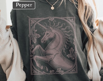 May include: Dark gray sweatshirt with a vintage-style unicorn graphic in a decorative frame. The word "Pepper" is printed on the upper left. The unicorn is a light purple color.
