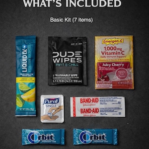 May include: A basic kit containing seven items, including Liquid I.V. electrolyte drink mix, Dude Wipes, Emergen-C vitamin C packets, Purell hand sanitizer, Band-Aid bandages, and Orbit wintermint gum. The kit is displayed on a dark gray surface.