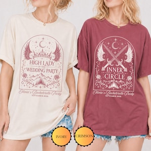 Puede incluir: Dos camisetas de manga corta y cuello redondo, una marfil y otra carmes&iacute;, con estampados gr&aacute;ficos. La camiseta marfil muestra una corona, alas y el texto High Lady of the Wedding Party. La carmes&iacute; muestra espadas cruzadas, alas y el texto Inner Circle. Ambas incluyen Olivia's Bachelorette Party September 2026.