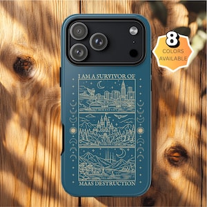 May include: A dark blue phone case featuring a three-panel gold line art illustration of cityscapes and landscapes. The text reads I AM A SURVIVOR OF MAAS DESTRUCTION, CRESCENT CITY, TERRASEN, and VELARIS. A badge in the corner states 8 COLORS AVAILABLE.