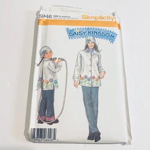 May include: Simplicity sewing pattern 5946, featuring a design for a jacket and hat. The pattern includes illustrations of the finished garments, with floral embellishments and the text "DAISY KINGDOM". The size range is A 3-4/XS-XL.