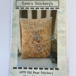 May include: A beige pillow with embroidery of a bear and the text "My old Bear is my best friend". The pillow is labeled "#373 Old Bear Stitchery".