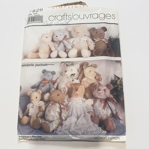 May include: A Simplicity 7826 sewing pattern envelope for stuffed bears in three sizes. The front features illustrations of various teddy bears in different fabrics, colors, and lace outfits, with the text crafts/ouvrages and marjorie puckett.