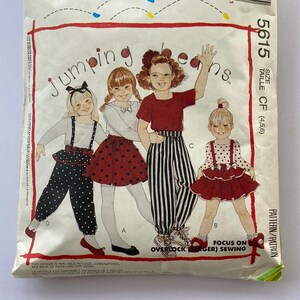 May include: A vintage sewing pattern for children's clothing. The pattern is for "Jumping Beans" and includes four different designs for girls. The pattern is for sizes 4, 5, and 6. The pattern is titled "Jumping Beans" and the pattern number is 5615.