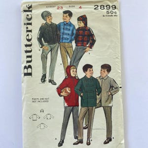 May include: Vintage sewing pattern for boys' coats and jackets. The pattern includes instructions for making a hooded coat, a double-breasted coat, and a trench coat. The pattern is for chest size 23 and size 4. The pattern number is 2899.