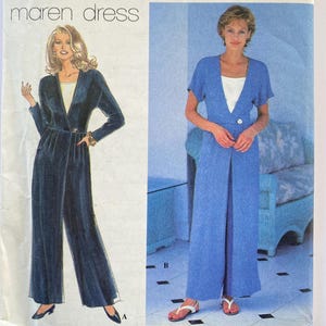 May include: A sewing pattern for a long, loose-fitting dress with a V-neckline and long sleeves. The pattern is called "Maren Dress" and is shown in two versions: one with a dark blue fabric and one with a light blue fabric.