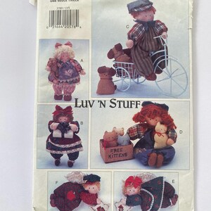May include: A pattern for making six different rag dolls. The dolls are dressed in various outfits and are holding different accessories. The pattern includes instructions for making the dolls and their accessories. The pattern is titled "Luv 'N Stuff".