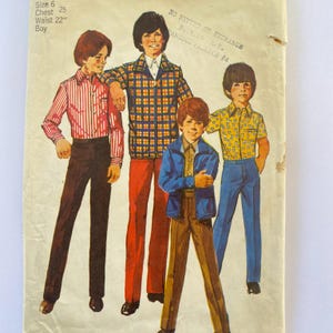 May include: A vintage sewing pattern for boys' clothing. The pattern includes four different outfits: a striped shirt with pants, a plaid shirt with pants, a blue jacket with pants, and a patterned shirt with pants. The pattern is for size 6, chest 25 inches, waist 22 inches.