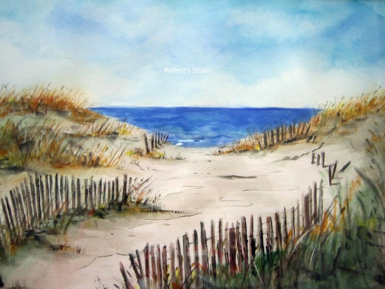 May include: A watercolor painting of a beach scene with a path leading to the ocean. The path is lined with wooden fences and the sand is a light beige color. The ocean is a deep blue and the sky is a light blue with white clouds. The text "Robert's Studio" is in the upper right corner of the painting.