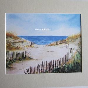 May include: Watercolor painting of a beach scene with a wooden fence leading to the ocean. The sky is blue and the water is a light blue. The sand is white and there are some green plants in the foreground. The text "Robert's Studio" is in the upper center of the image.
