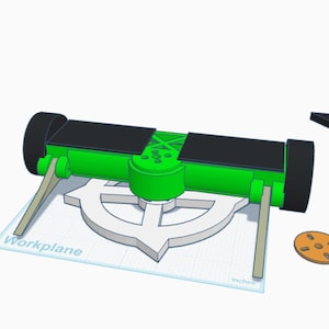 May include: A green and black robotic chassis with two wheels, two light-colored angled supports, and a central circular component. Beside it are a black propeller-like blade, a small orange circular disc, and two red angled components.