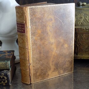 May include: A vintage leather-bound book with gold accents and the title "Byron's Poetical Works." on the spine.