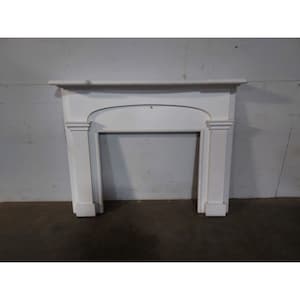 May include: White painted wooden fireplace mantel with a simple arched opening. The mantel is freestanding and has a plain design.