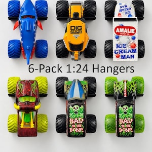 May include: A 6-pack of 1:24 scale monster truck hangers. The set includes a blue shark truck, a yellow Digatron truck, an Ice Cream Man truck, a red and yellow truck, and two black Bad to the Bone trucks with green skull graphics.