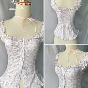 May include: A white blouse with a pink floral print, featuring a square neckline, ruffled cap sleeves, and a front button placket. The garment includes a light pink ribbon tied at the neck and a smocked back panel. The text Hani Pattern Co. is visible.