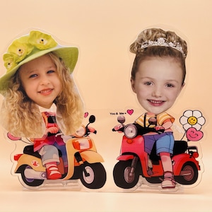May include: Two cut-out figures of children on scooters. One child wears a yellow hat and rides an orange scooter. The other child wears a crown and rides a red scooter. The words "You & Me" are printed on the image.