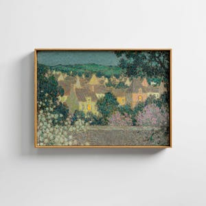 May include: A framed painting depicts a nighttime village scene. The artwork features houses with lit windows, surrounded by trees and flowers. The color palette includes greens, blues, and yellows, with a gold-colored frame.