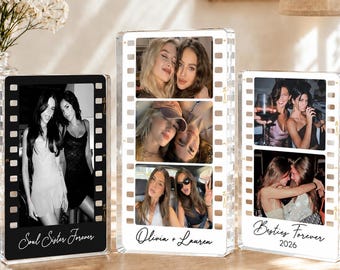 May include: Three rectangular acrylic photo frames designed like vintage film strips. Each frame displays personal photographs and custom text, including "Soul Sister Forever," "Olivia + Lauren," and "Besties Forever 2026," printed on the base.