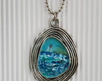 Hand painted jewelry. This is a one of a kind pendant necklace set in an amazing unique metal bezel. Sailboat at sea.Handmade. Very textured