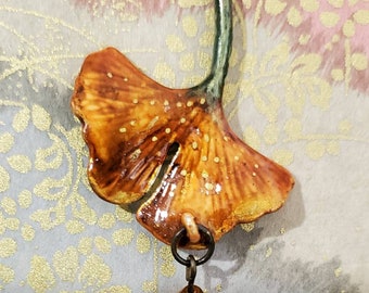 Beautiful handpainted ginkgo leaf pendant necklace.  Original. One of a kind. Wearable art.  Handmade hand painted. Golds with glass bead.