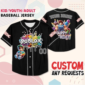 May include: Black baseball jersey with the word "ROBLOX" in colorful paint-drip style. The jersey has the text "KID/YOUTH/ADULT BASEBALL JERSEY" at the top. The back of the jersey has the text "YOUR NAME" and a graphic that says "HAPPY BIRTHDAY".