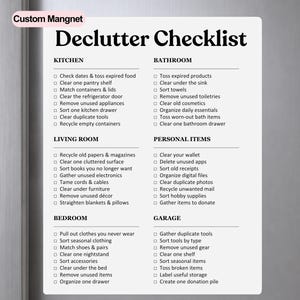 May include: A white rectangular magnetic checklist with black text titled Declutter Checklist. It features categorized sections for Kitchen, Bathroom, Living Room, Personal Items, Bedroom, and Garage, each containing a list of tasks with checkboxes.