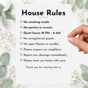 May include: A rectangular white sign with black text titled House Rules. The list includes: No smoking inside, No parties or events, Quiet hours: 10 PM - 8 AM, No unregistered guests, No open flames or candles, Please respect our neighbours, Report any damage immediately, Please treat our home with care, and Thank you for staying with us.