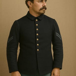 May include: A black wool Civil War era jacket with gold buttons and sergeant stripes on the sleeves. The jacket is paired with a matching hat. The image includes the text "MantharCrafts".