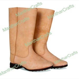 May include: A pair of tall, light tan leather boots. The boots have a simple design with a rounded toe and a flat, black sole. The boots appear to be new and unworn, with a smooth, clean surface. The boots are suitable for various outdoor activities.
