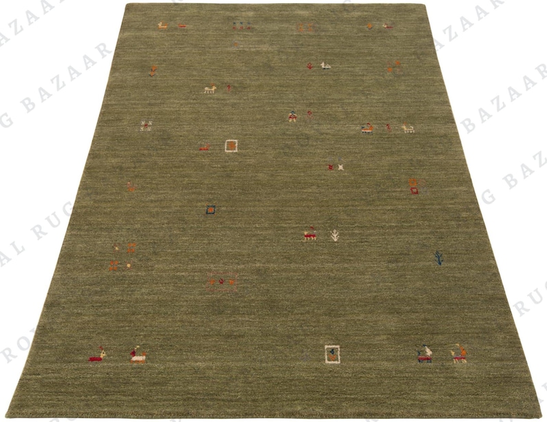 May include: A rectangular olive green rug with a subtle textured surface. The rug features scattered, colorful, abstract designs, including small squares, rectangles, and stylized figures in red, orange, and white.