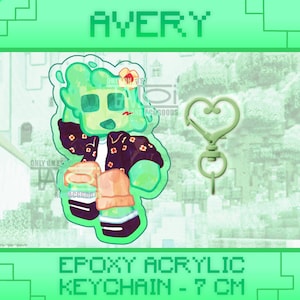 May include: Avery epoxy acrylic keychain featuring a green cartoon character with a floral jacket and a heart-shaped clasp. The keychain is approximately 7 cm in length. The word "AVERY" is at the top of the image.