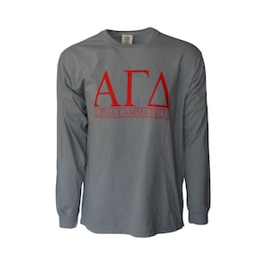 May include: A gray long-sleeve t-shirt with the letters "ΑΓΔ" in red, and the words "ALPHA GAMMA DELTA" in red below the letters.